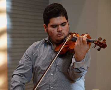 javier torres violin player with the icopr