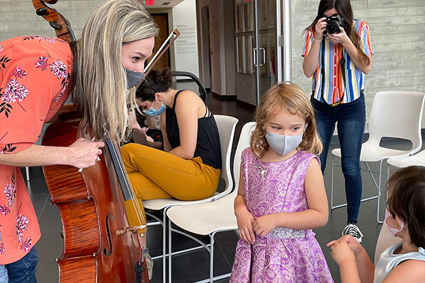young girl learning about the cello