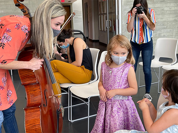 icopr player teaching children about the cello